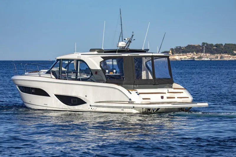Slide: The Image of 2025 Marex 440 Gourmet Cruiser yacht on open water, sleek design, sunny day. - 12