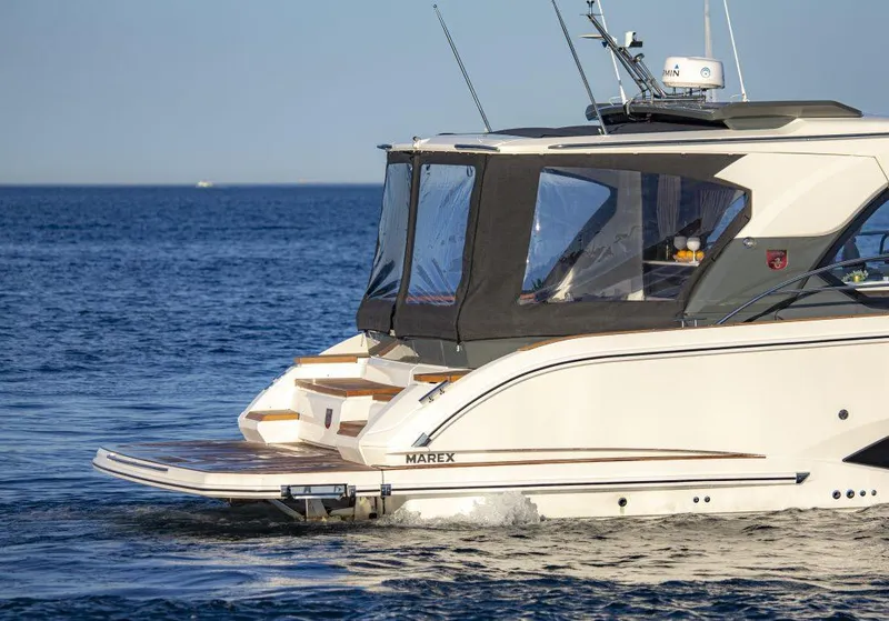 Slide: The Image of 2025 Marex 440 Gourmet Cruiser yacht on calm blue sea. - 14