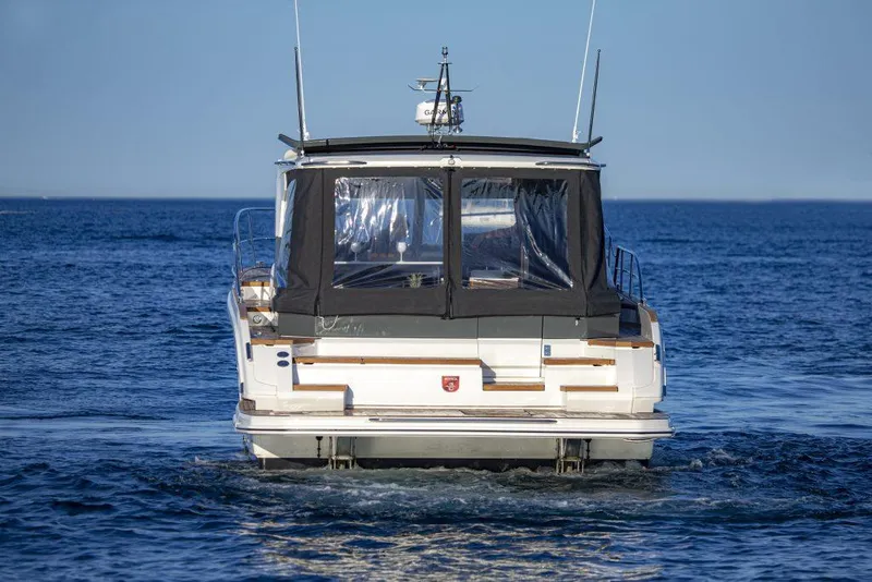 Slide: The Image of 2025 Marex 440 Gourmet Cruiser on open water, rear view. - 15