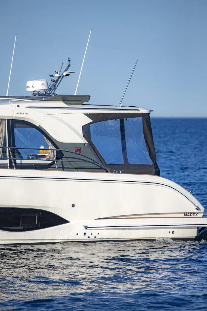 Slide: The Image of 2025 Marex 440 Gourmet Cruiser yacht on calm blue sea. - 16