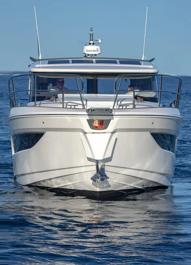 Slide: The Image of 2025 Marex 440 Gourmet Cruiser yacht on calm blue water. - 18