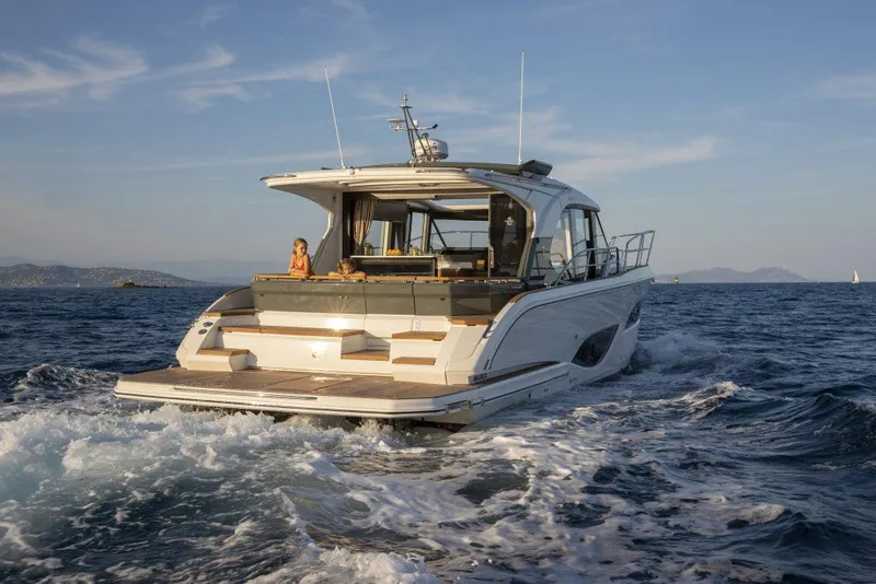Slide: The Image of 2025 Marex 440 Gourmet Cruiser navigating ocean waters, rear view. - 26