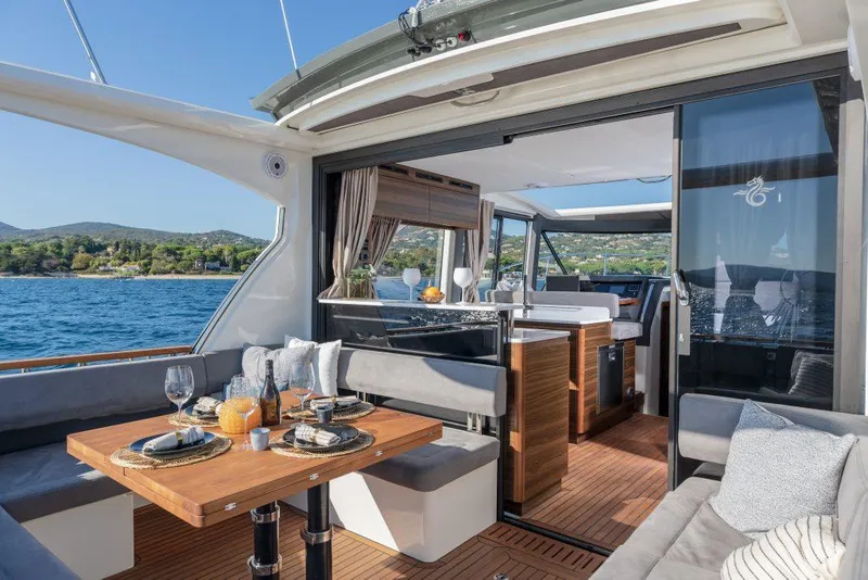 Slide: The Image of Luxurious Marex 440 Gourmet Cruiser 2025 yacht interior with elegant dining setup and scenic ocean view. - 29