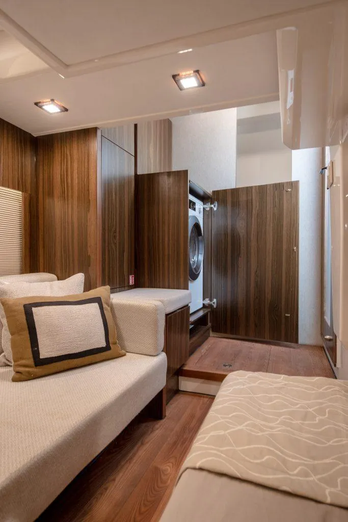 Slide: The Image of Interior of 2025 Marex 440 Gourmet Cruiser with modern wood paneling and cozy seating. - 32