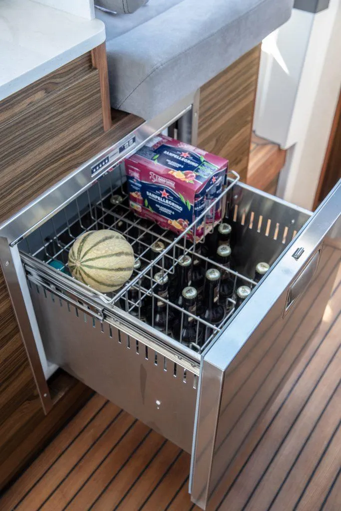 Slide: The Image of Open drawer fridge on Marex 440 Gourmet Cruiser, stocked with drinks and a melon. - 43
