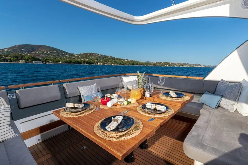 Slide: The Image of Luxurious dining setup on 2025 Marex 440 Gourmet Cruiser yacht, overlooking serene waters. - 48