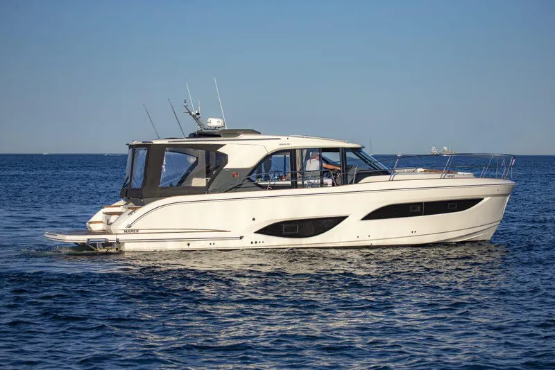 Slide: The Image of 2025 Marex 440 Gourmet Cruiser yacht on open water, side view. - 13