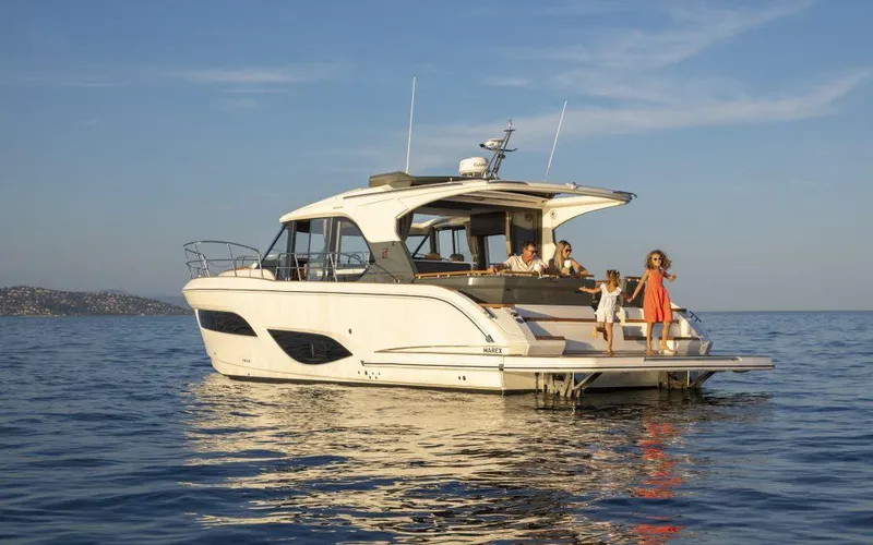 Slide: The Image of 2025 Marex 440 Gourmet Cruiser yacht on calm sea with people enjoying the view. - 22