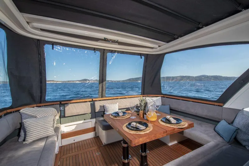 Slide: The Image of Luxurious interior of 2025 Marex 440 Gourmet Cruiser with ocean view and elegant dining setup. - 31