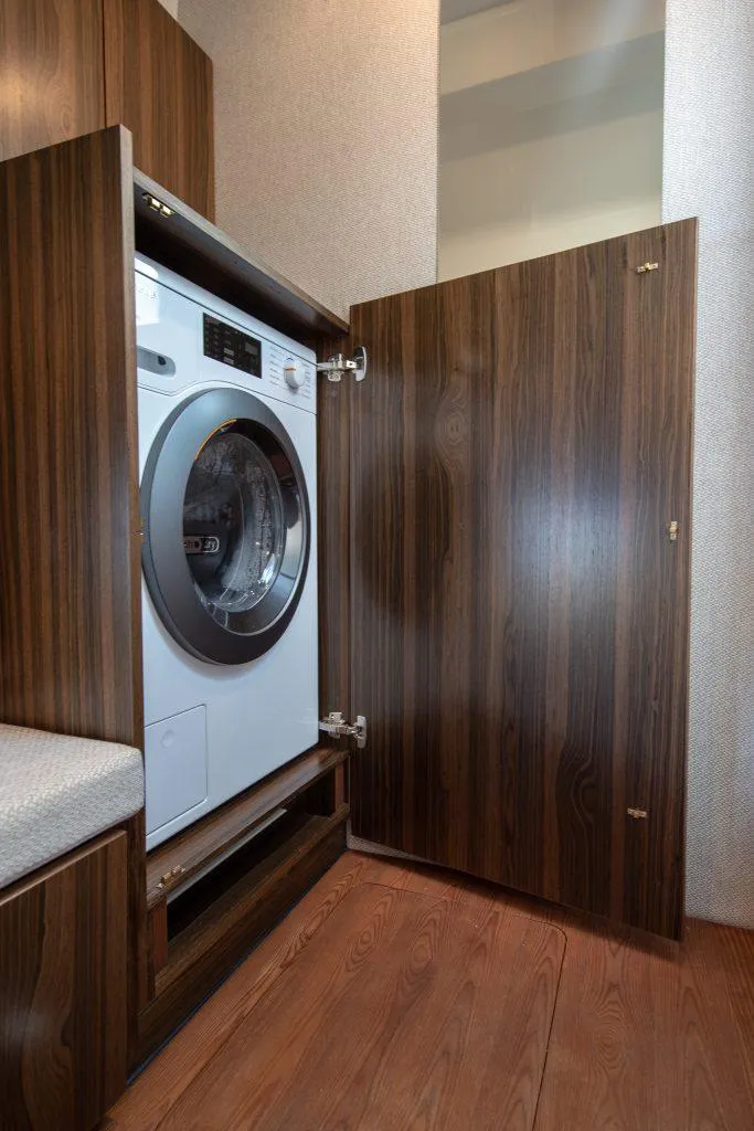 Slide: The Image of 2025 Marex 440 Gourmet Cruiser interior with built-in washing machine in wooden cabinet. - 33