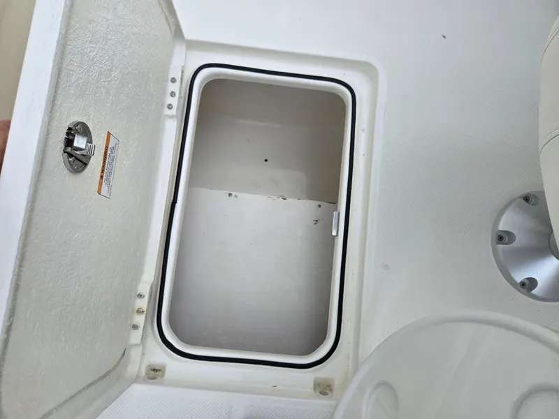 Slide: The Image of Open storage compartment on 2015 Bayliner 642 Overnighter boat. - 15