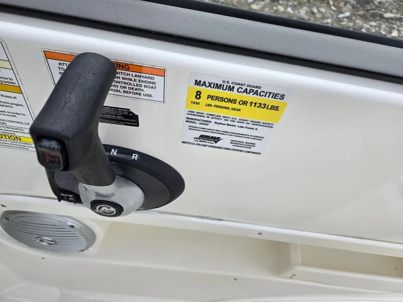 Slide: The Image of 2015 Bayliner 642 Overnighter boat control panel with capacity label for 8 persons. - 16