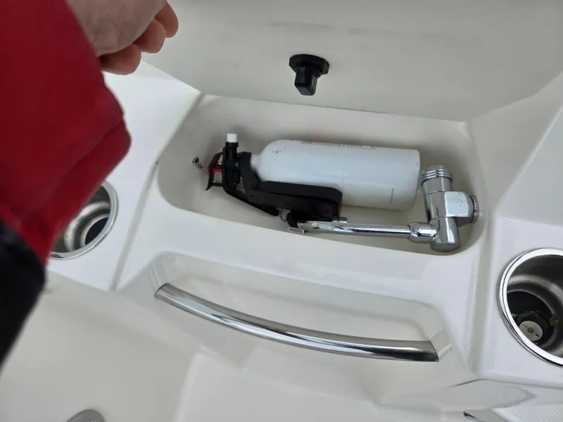 Slide: The Image of 2015 Bayliner 642 Overnighter boat compartment with faucet and storage space. - 18