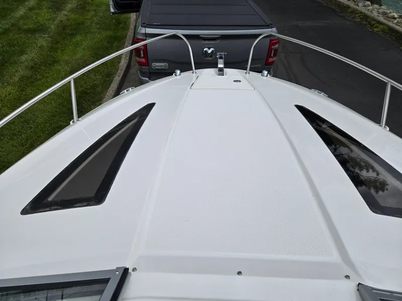 Slide: The Image of 2015 Bayliner 642 Overnighter boat bow with truck in background. - 19