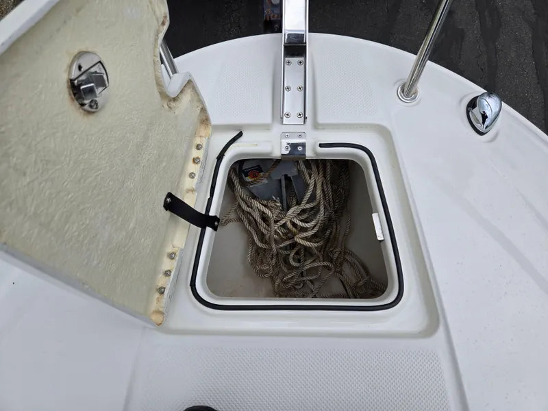 Slide: The Image of Open storage compartment on 2015 Bayliner 642 Overnighter boat with ropes inside. - 20
