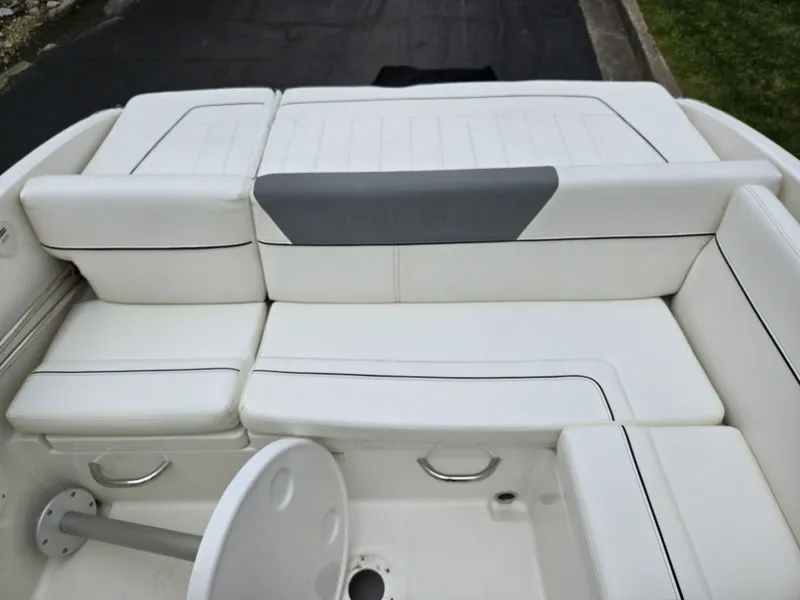 Slide: The Image of 2015 Bayliner 642 Overnighter boat interior with white cushioned seating. - 23