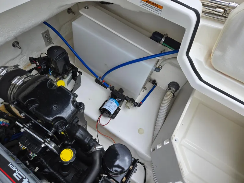 Slide: The Image of Engine compartment of a 2015 Bayliner 642 Overnighter boat, showcasing mechanical components. - 25