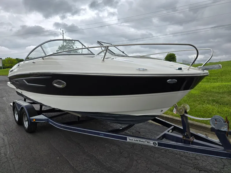 Slide: The Image of 2015 Bayliner 642 Overnighter boat on trailer, parked on a paved road. - 5