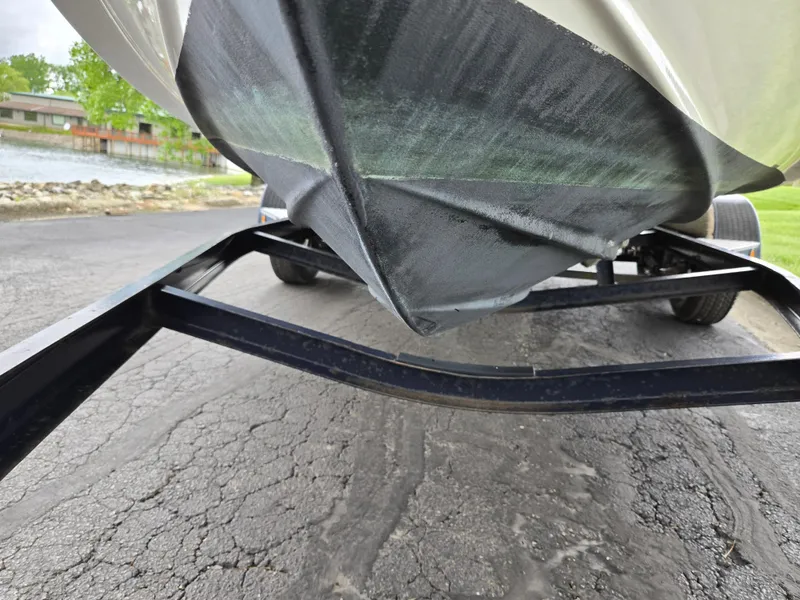 Slide: The Image of 2015 Bayliner 642 Overnighter boat on trailer, showing hull and trailer details. - 7