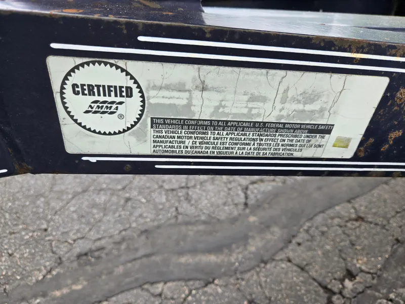 Slide: The Image of Certified NMMA label on a 2015 Bayliner 642 Overnighter boat trailer. - 8