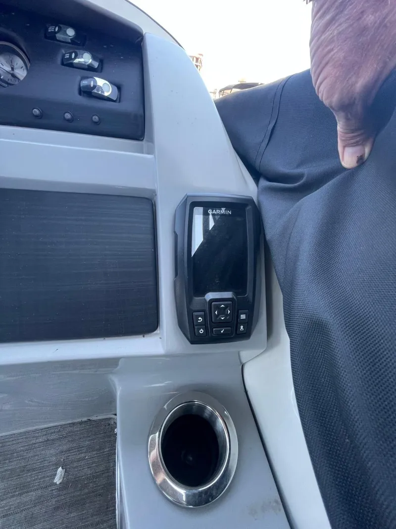 Slide: The Image of Control panel of a 2021 Bennington 24LSR boat with cup holder. - 12