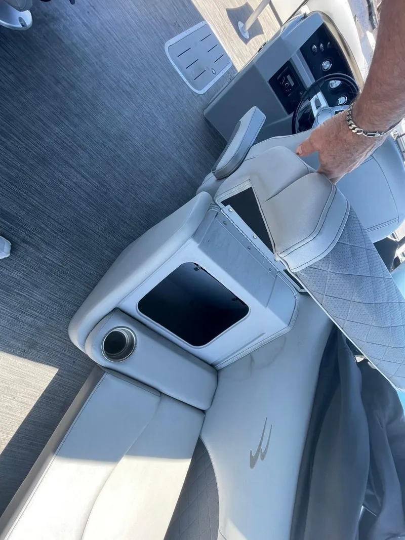 Slide: The Image of 2021 Bennington 24LSR boat interior with gray seating and cup holder. - 16