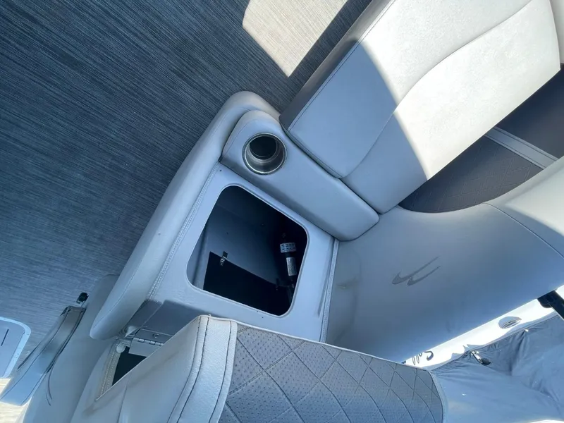 Slide: The Image of Interior of 2021 Bennington 24LSR boat showing seating and storage compartment. - 17