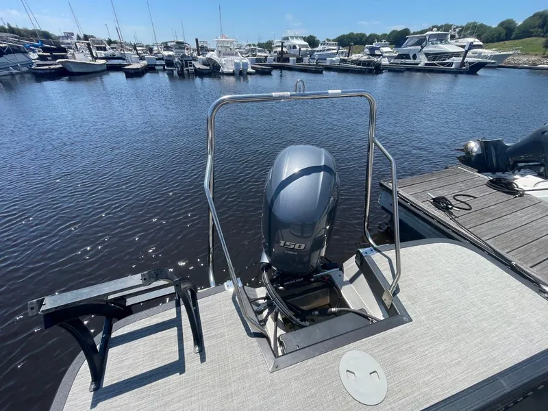 Slide: The Image of 2021 Bennington 24LSR pontoon boat with 150 HP engine docked at marina. - 19