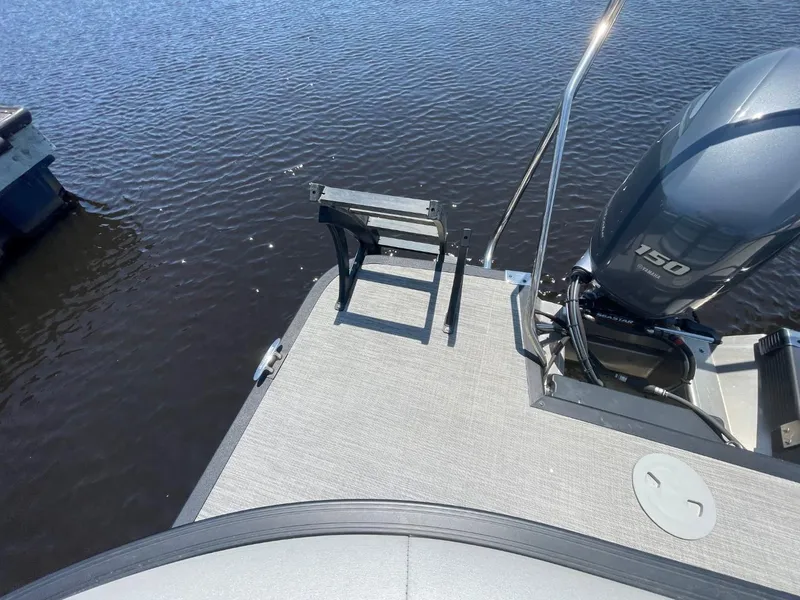 Slide: The Image of 2021 Bennington 24LSR pontoon boat with 150 HP motor on calm water. - 20