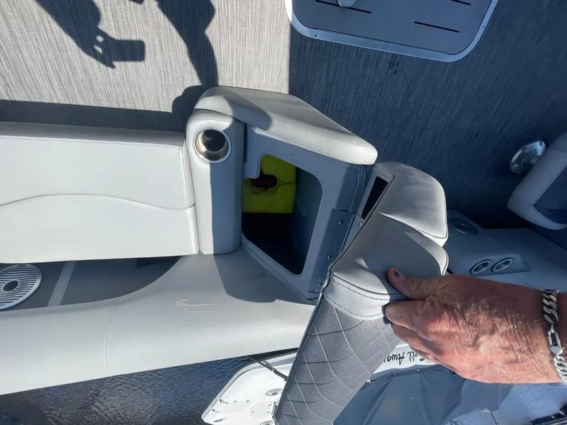 Slide: The Image of 2021 Bennington 24LSR boat seat storage compartment with cup holder and hand opening cushion. - 22