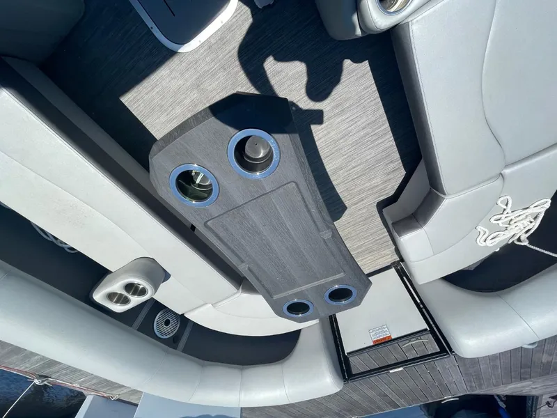 Slide: The Image of 2021 Bennington 24LSR boat interior with gray seating and cup holders. - 23