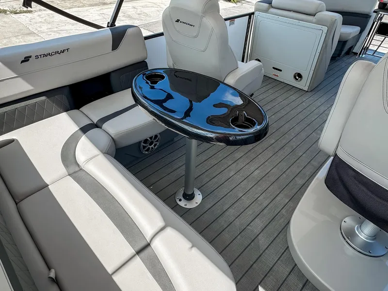 Slide: The Image of 2024 Starcraft CX 23 Q DH boat interior with seating and table. - 12