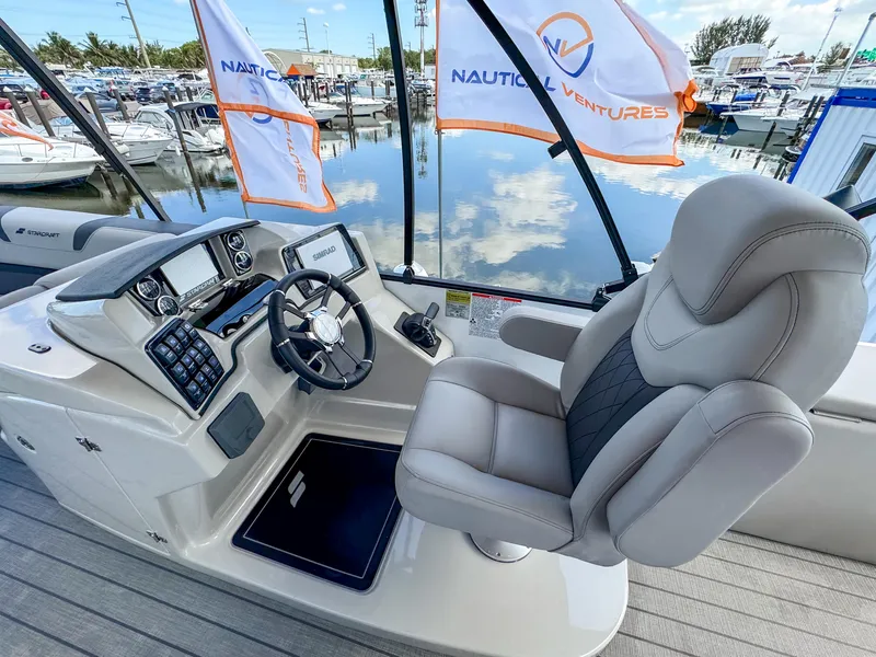 Slide: The Image of 2024 Starcraft CX 23 Q DH boat helm with luxurious seating and modern controls. - 13