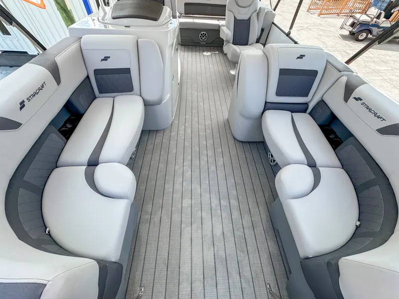 Slide: The Image of 2024 Starcraft CX 23 Q DH pontoon boat interior with plush seating and modern design. - 16