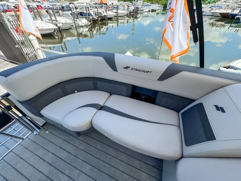 Slide: The Image of Luxurious seating on 2024 Starcraft CX 23 Q DH boat at marina. - 18