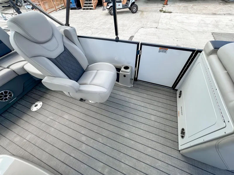 Slide: The Image of 2024 Starcraft CX 23 Q DH boat interior with gray seating and flooring. - 22