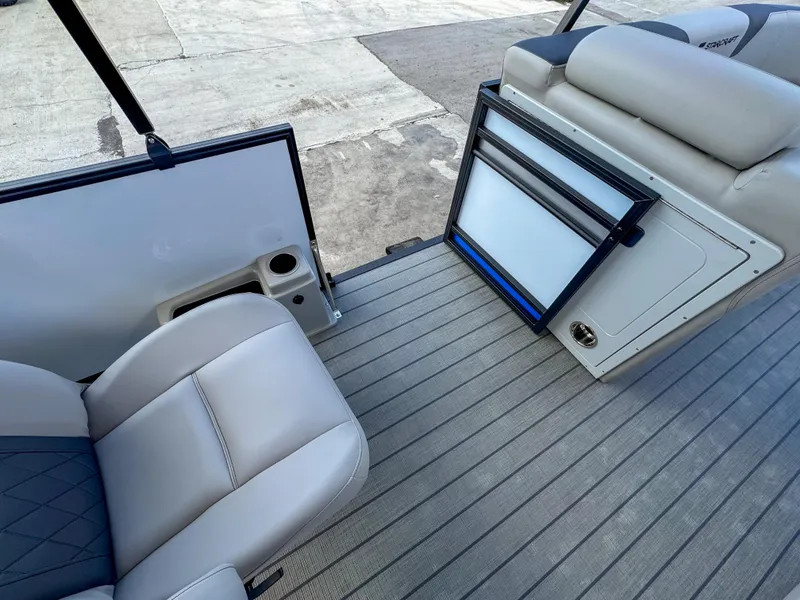 Slide: The Image of 2024 Starcraft CX 23 Q DH boat interior with seating and storage compartments. - 23