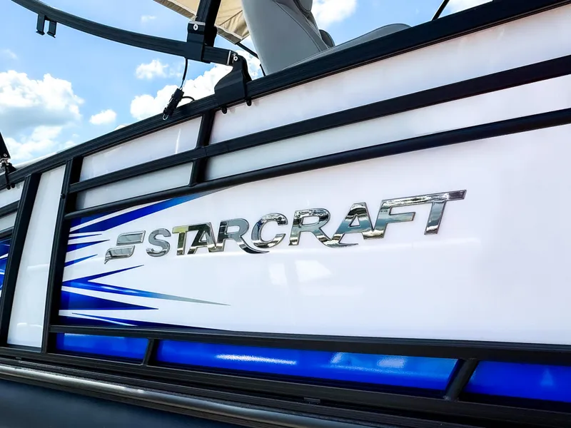 Slide: The Image of 2024 Starcraft CX 23 Q DH boat with sleek design and blue accents. - 6