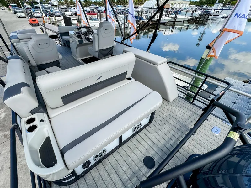 Slide: The Image of 2024 Starcraft CX 23 Q DH pontoon boat interior with plush seating and modern design. - 8