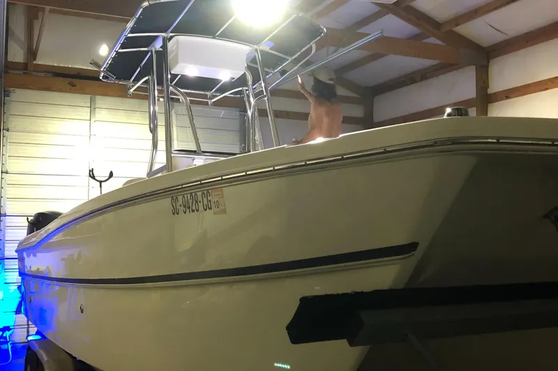 Slide: The Image of 2013 Carolina Cat 230 CC boat in a garage, under bright lighting. - 5