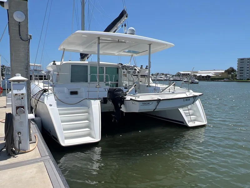 Slide: The Image of 2008 Lagoon 420 catamaran docked at marina under clear blue sky. - 13