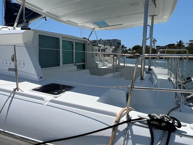 Slide: The Image of 2008 Lagoon 420 catamaran docked, featuring spacious deck and modern design. - 14