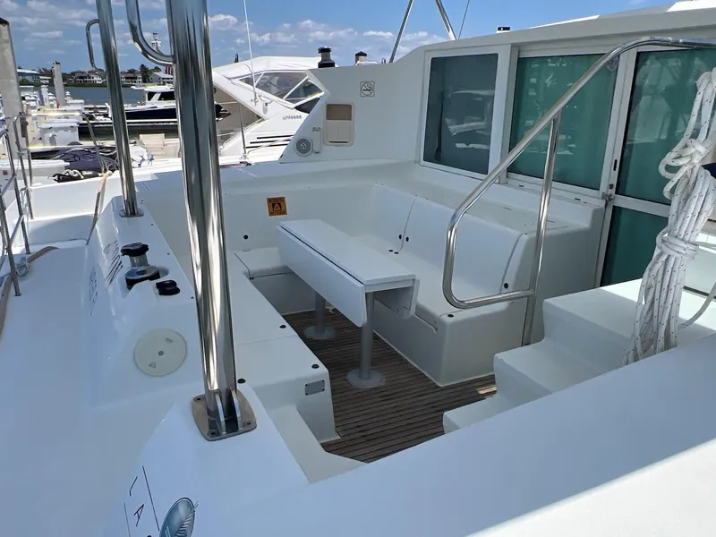 Slide: The Image of 2008 Lagoon 420 yacht deck with seating area and marina view. - 20