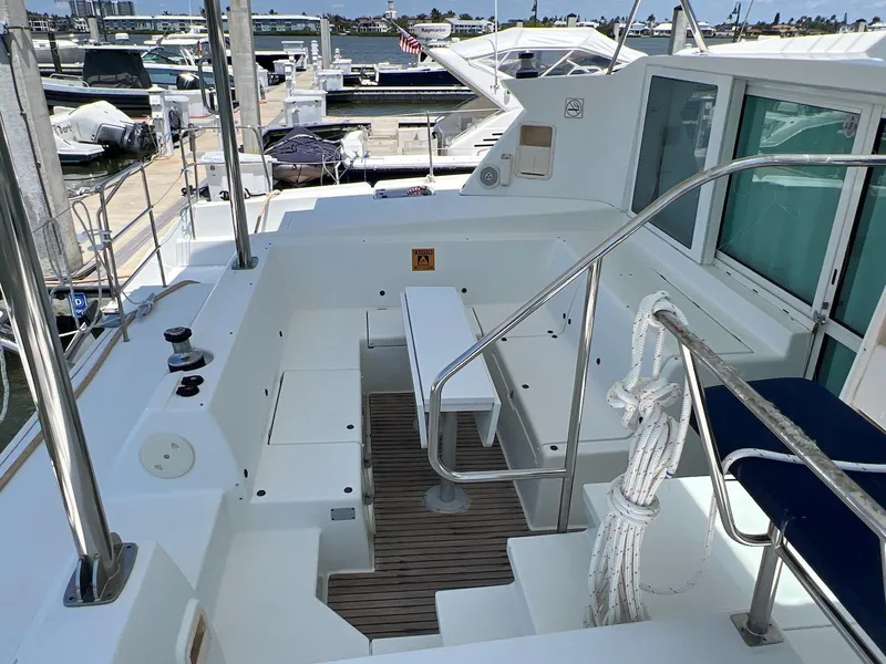 Slide: The Image of 2008 Lagoon 420 yacht deck with seating and marina view. - 21