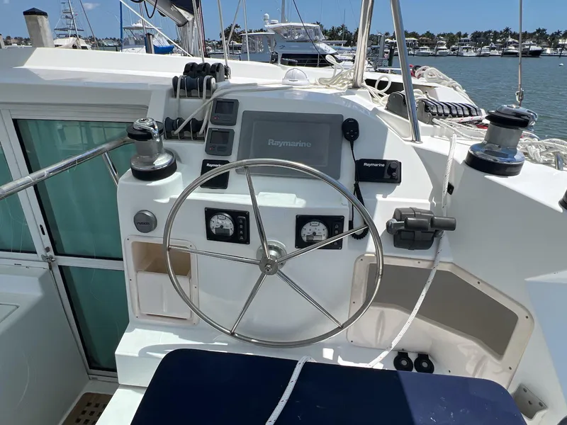 Slide: The Image of Helm of 2008 Lagoon 420 catamaran with steering wheel and navigation instruments. - 23