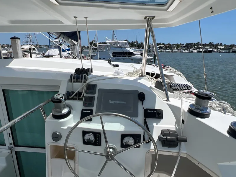 Slide: The Image of Cockpit of 2008 Lagoon 420 catamaran with steering wheel and navigation equipment. - 24