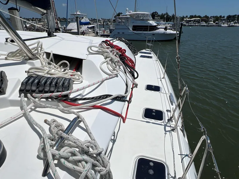 Slide: The Image of 2008 Lagoon 420 sailboat deck with ropes and marina view. - 28