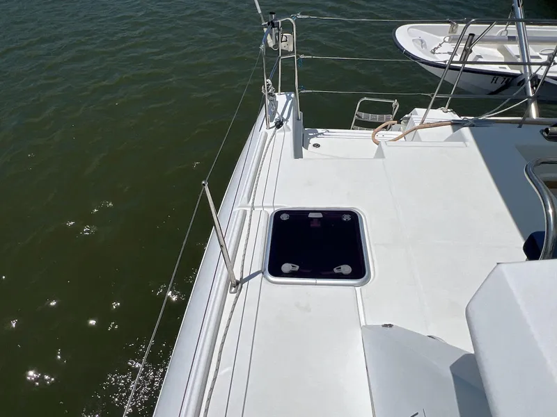 Slide: The Image of 2008 Lagoon 420 yacht deck with open hatch, overlooking calm water. - 29
