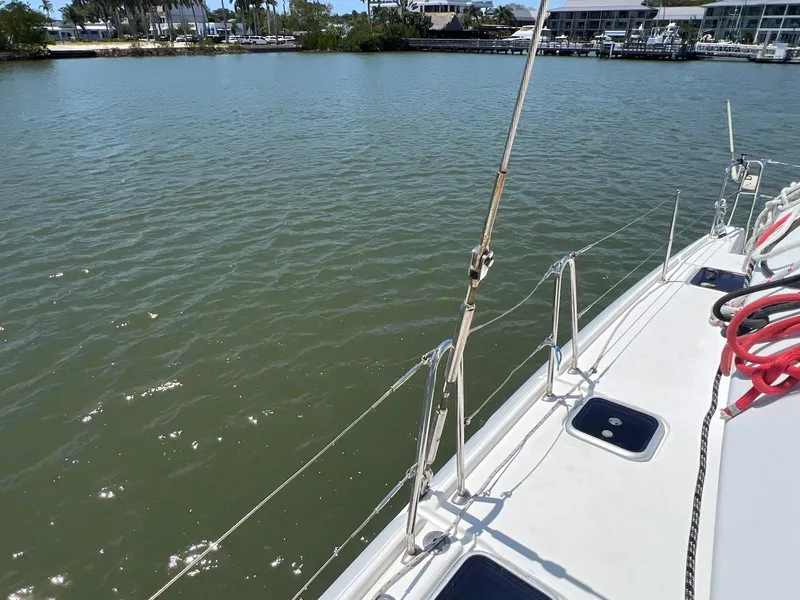 Slide: The Image of 2008 Lagoon 420 sailboat on calm water near a marina. - 30