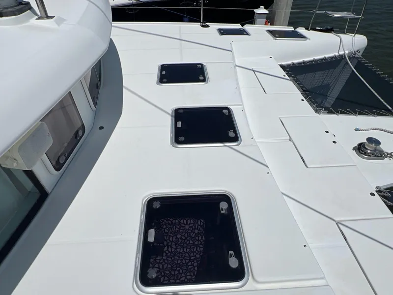 Slide: The Image of Deck view of 2008 Lagoon 420 catamaran with multiple hatches and sleek design. - 39